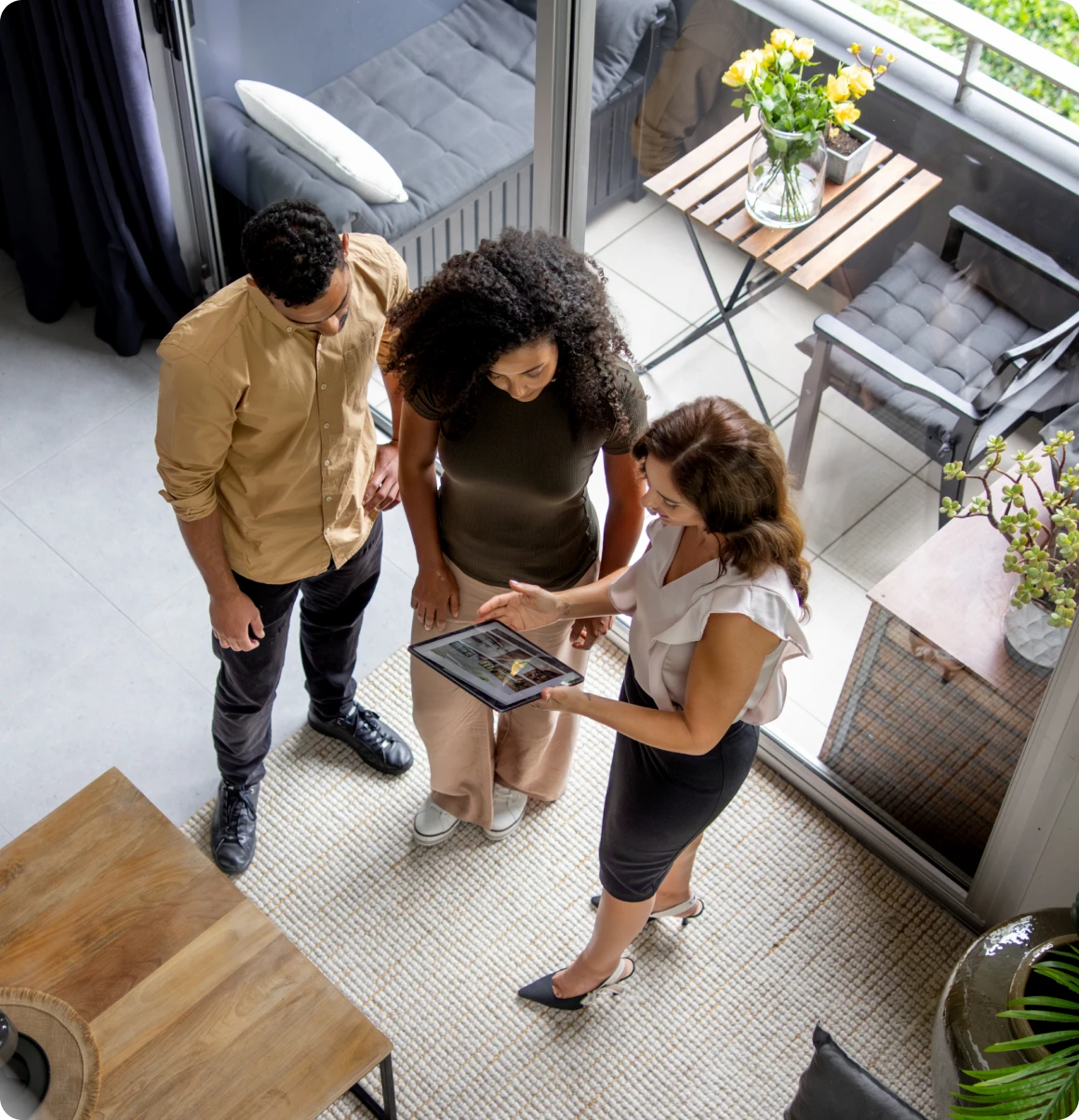 People looking at a tablet indoors.